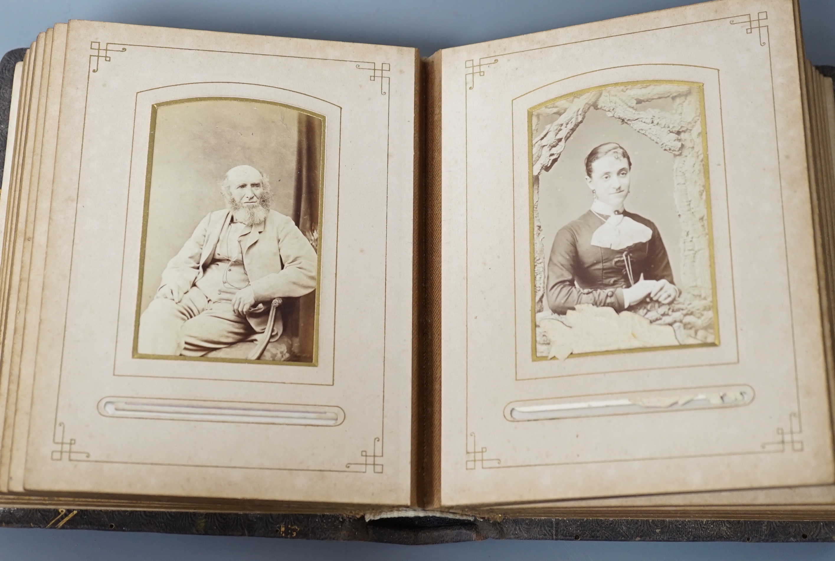 A Victorian portrait photograph album in clasp bound book containing cabinet cards